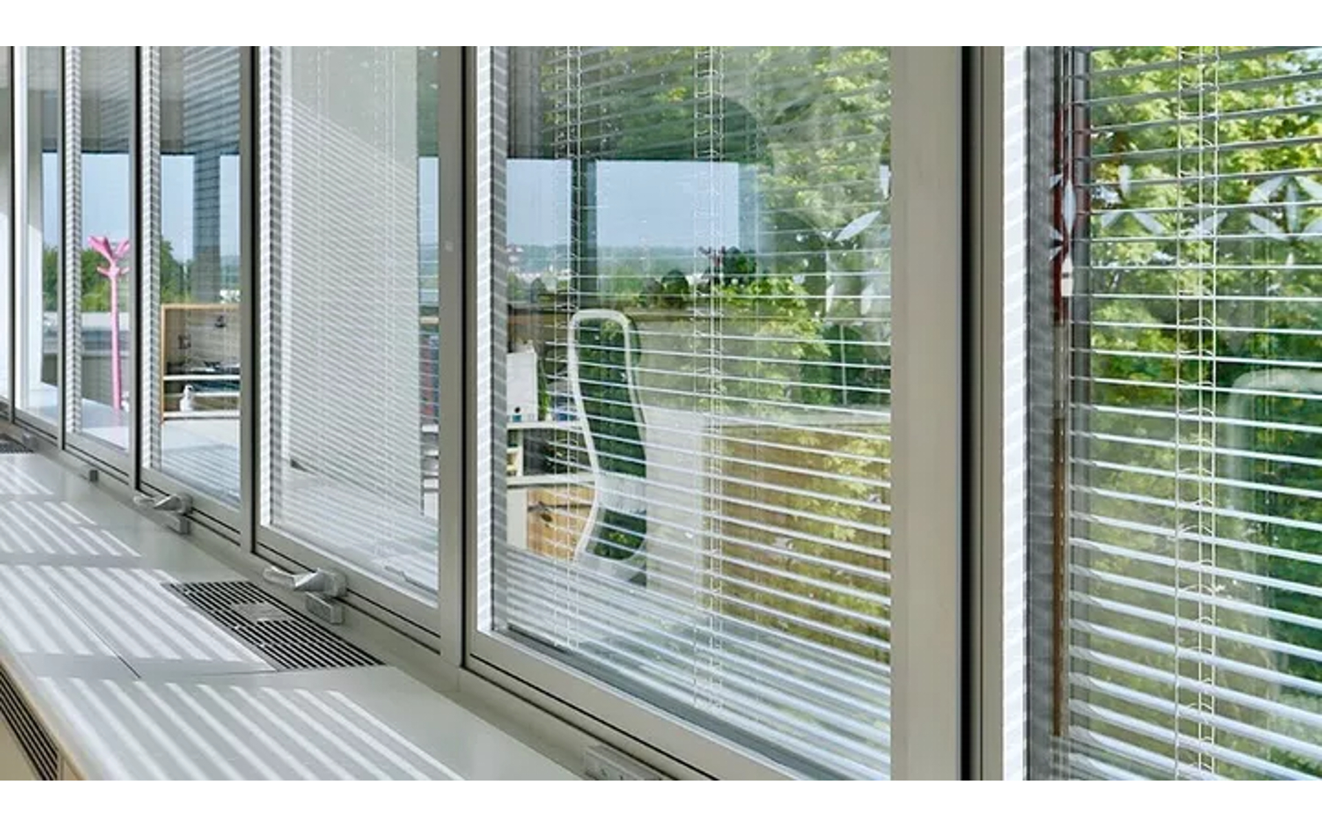 Integrated glass blinds installed in a window